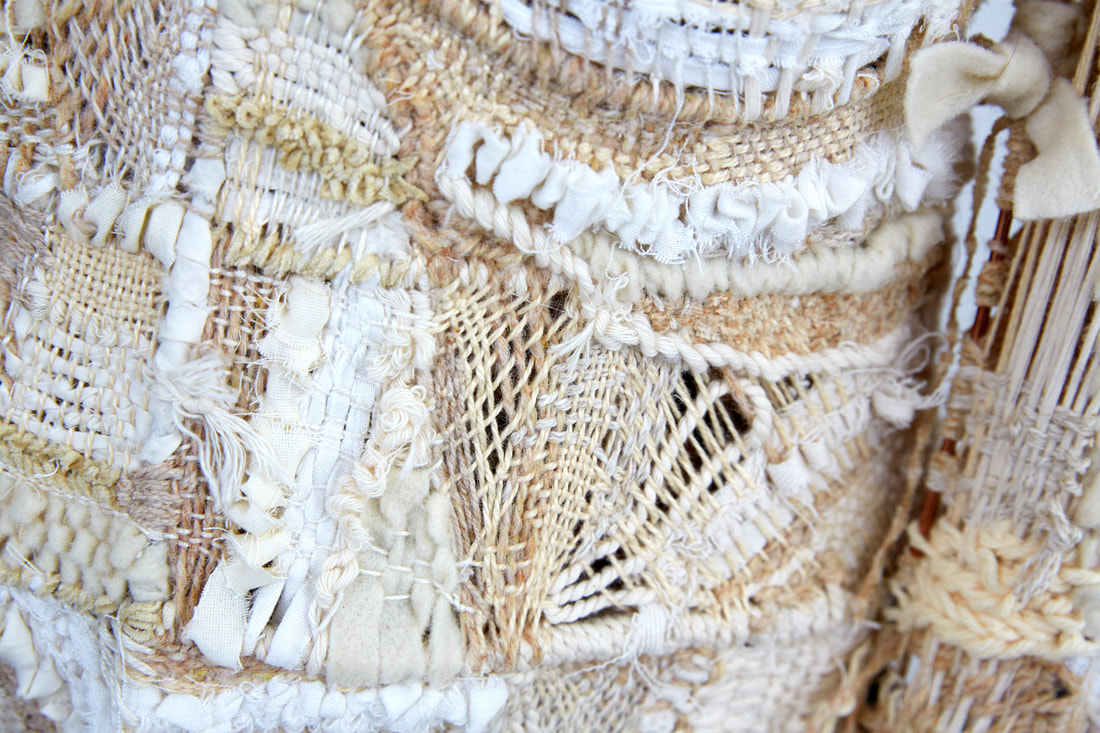 Zoomed in view of woven cream fiber creating skin of female figurative sculpture